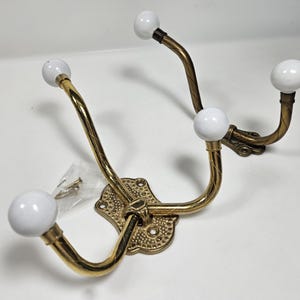 May include: A set of three ceramic mugs with a speckled, matte finish. Each mug features a different color: light blue, cream, and gray. The mugs have a simple, modern design and a comfortable handle.