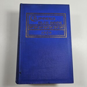 May include: A blue hardcover book with gold lettering on the front cover. The title is "California Blue Book" and the year is "1903".