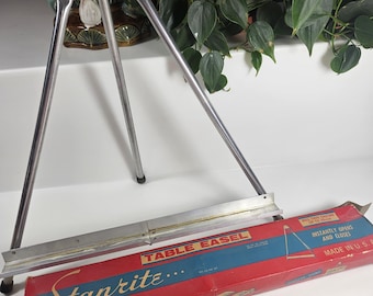 vtg used metal tabletop easel in original box // holds canvas up to 24 x 20 inches // folds up // 18 x 18 inch when open