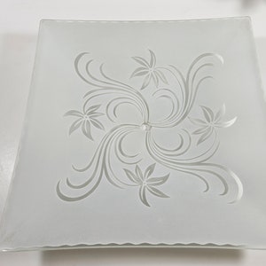 May include: White frosted glass ceiling light fixture with a square shape and a floral design etched into the surface.