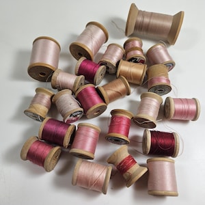 24 vtg wood spools with pink threads // height range 1 - 2.75 inches