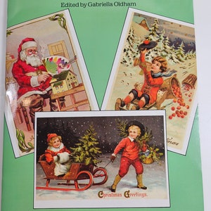 May include: A book cover featuring three vintage Christmas cards. The cards depict a Santa Claus painting, a child sledding with a basket of apples, and a child pulling a sled with a Christmas tree. The book title is "Old-Fashioned Christmas Cards" and the text "24 Full-Color Cards" is at the bottom.