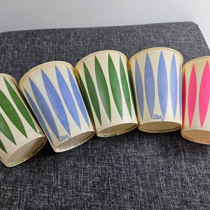 5-piece Dixie Waxed Paper Cups, 9 ounce, with age discoloration from storage // Surfer pattern, 3 colors // unused // 3.6 inches tall
