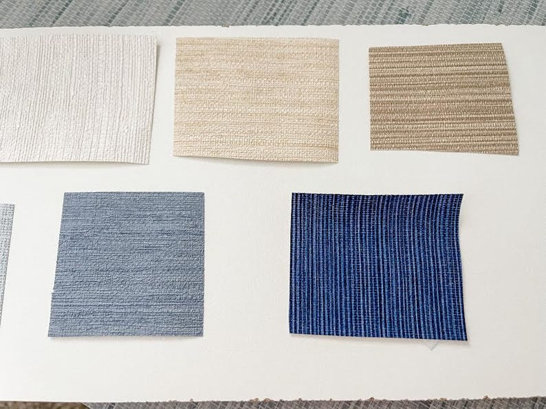 May include: Five samples of wallpaper in different colors and textures. The samples are arranged in two rows, with three samples in the top row and two samples in the bottom row. The samples are all rectangular and have a smooth surface. The colors of the samples are white, beige, brown, blue, and dark blue.