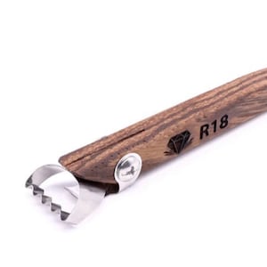 May include: A wooden citrus peeler with a stainless steel blade and a diamond logo with the text "R18".