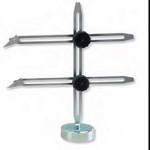 May include: A silver metal tool with two adjustable arms and a circular base. The arms are held in place by black knobs. The tool is used for measuring and transferring dimensions.