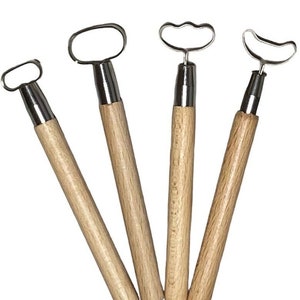 May include: Set of four metal and wood sculpting tools with different shaped tips. The tools are used for shaping clay or other soft materials.