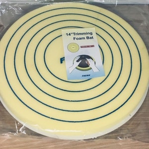 May include: A 14-inch round foam buffing pad with a yellow centre and blue concentric circles. The pad is packaged in a clear plastic bag. The label on the bag reads "14" Trimming Foam Bat" with the item number "FOP-14".