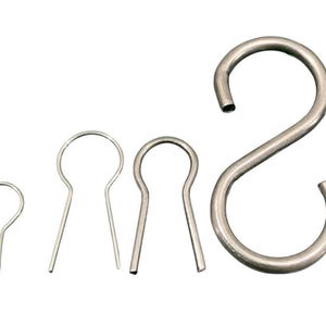 May include: Set of four silver metal hooks, including a large S-shaped hook and three smaller hooks with rounded ends.