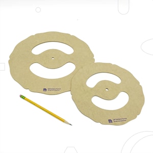 May include: Two wooden pottery forms with a centre hole and two curved cutouts. The forms are light brown and have the text "GR Pottery Forms Durable and Economical" printed on them.