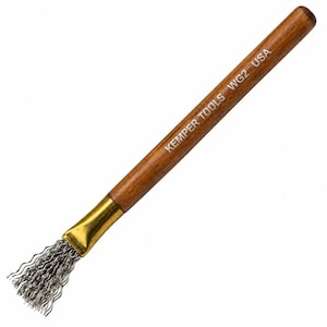 May include: A wire texture tool with a smooth brown wooden handle and a gold-coloured metal ferrule. The tip consists of fine, wavy silver-coloured metal bristles. The handle is printed with the white text KEMPER TOOLS WG2 USA.