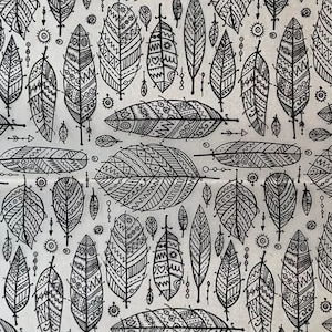 May include: A seamless pattern of black and white stylised feathers with intricate geometric designs on a white background.