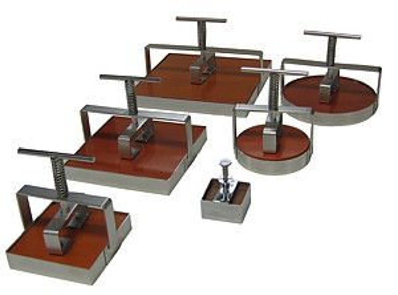 May include: Set of six stainless steel cookie cutters with wooden handles. The cutters are in various shapes, including square, round, and rectangular.