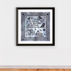 May include: Framed artwork with a black border. The artwork features a quote about crows, with illustrations of crows and floral elements. The background has a textured, light blue and gray pattern.