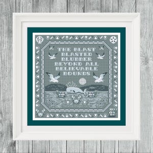 May include: A framed cross-stitch artwork with a teal and gray color scheme. The text reads "THE BLAST BLASTED BLUBBER BEYOND ALL BELIEVABLE BOUNDS." The design includes whales, seagulls, and a coastal scene.