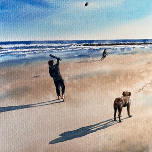 May include: A watercolor painting of a person swinging a bat at a ball on a beach with a dog standing nearby. The sky is blue and the water is a light blue. The sand is a light brown.
