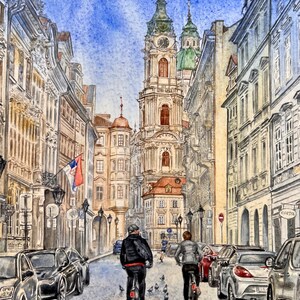 May include: A watercolor painting of a narrow street in a European city. The street is lined with tall buildings, and there are two people riding bicycles in the foreground. The sky is blue and there are some clouds.