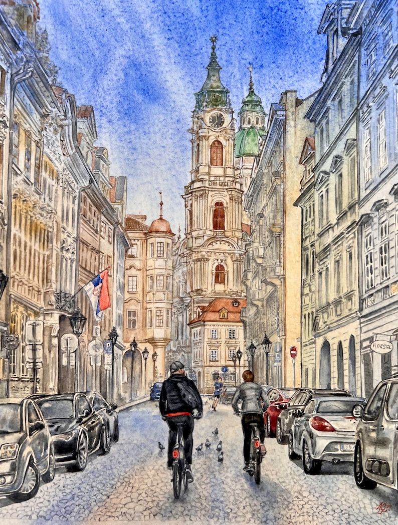 May include: A watercolor painting of a narrow street in a European city. The street is lined with tall buildings, and there are two people riding bicycles in the foreground. The sky is blue and there are some clouds.