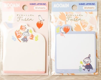 May include: Two packs of Moomin die-cut sticky notes, each containing 30 sheets. The left pack has a pink header and a cream-colored note pad, while the right pack has a blue header and a light blue note pad. Both feature Little My illustrations.