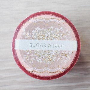 May include: A roll of decorative washi tape featuring a floral design and the text "SUGARIA tape." The tape has a pink and gold colour scheme with a dark red border. Ideal for scrapbooking, journaling, and crafts.
