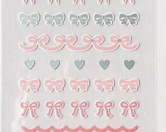 May include: Sheet of decorative stickers featuring bows, hearts, and scalloped borders in pastel pink, blue, and mint green. The stickers are labeled "mini series" and "suatelier design". The sheet is labeled "NO.121" and "DECO.13".
