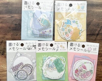 May include: Five packs of decorative stickers with Japanese text. Each pack contains various sticker designs, including floral, bunny, and patterned elements. The packs are in shades of blue, yellow, gray, green, and pink.
