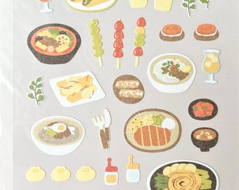 May include: A sheet of Daily Deco Stickers with illustrations of diverse foods, including tacos, sushi, and dumplings. The sheet also features the text "DAILY DECO STICKERS" and "1173: food trip #8". The stickers are designed for decoration.