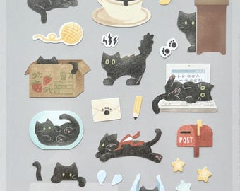 May include: Sheet of decorative stickers featuring black cat illustrations in various poses with accessories like a coffee cup, laptop, and mail. The stickers also include the text "DAILY DECO STICKERS" and "1197 : my little universe".