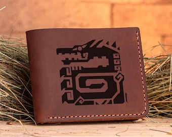 Puede incluir: Una cartera de cuero marrón con un diseño de dragón negro detallado en relieve en la parte delantera.