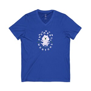 May include: A royal blue V-neck t-shirt featuring a central graphic of a light-colored wombat with a green nose. The text "WOMBAT WONTONS" is printed in white around the illustration, accompanied by small white floral accents and green text.