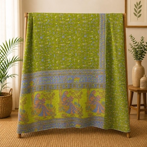 May include: A rectangular quilt featuring a vibrant lime green base with intricate blue and yellow patterns. The design includes a repeating motif of figures seated under trees in the lower section, separated by a horizontal band of floral details.