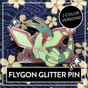 Puede incluir: Un pin de Flygon Pokémon de purpurina verde y rojo con un fondo brillante. El pin tiene el texto "2 COLOR VERSIONS!" y "FLYGON GLITTER PIN".