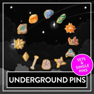 May include: A set of 12 colourful enamel pins featuring various underground rock formations, including crystals, gems, and fossils. The pins are arranged in a circle on a black background with stars. The text "SETS & SINGLE PINS" and "UNDERGROUND PINS" are displayed on the image.