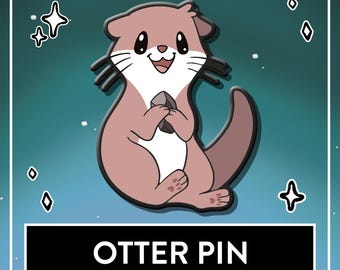 May include: A pink and white enamel pin featuring a cartoon otter holding a small gray rock. The otter has black eyes, whiskers, and a smiling mouth. Below the otter, a black rectangular box contains the white text OTTER PIN.