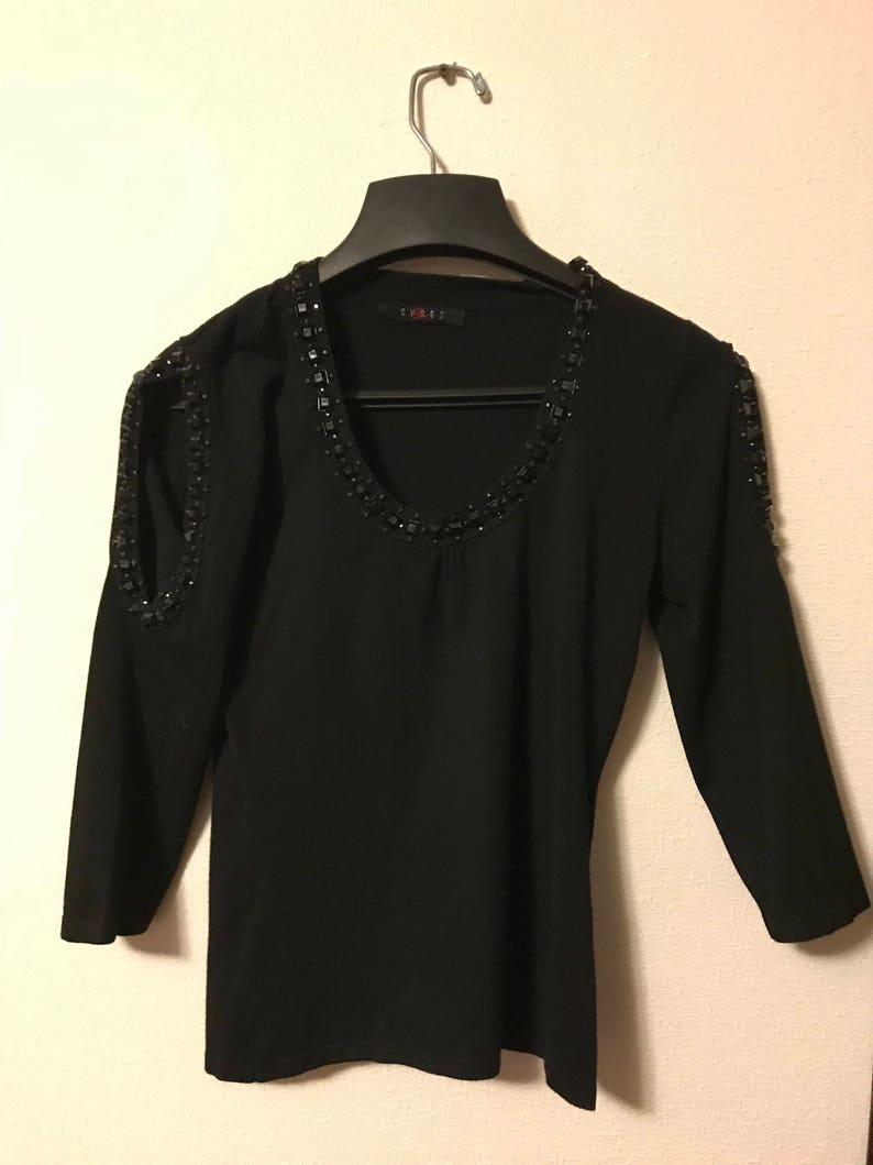 Gorgeous black sweater with black stones around the neck /& the open arms cutouts from Cypress