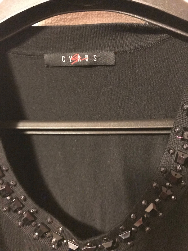 Gorgeous black sweater with black stones around the neck /& the open arms cutouts from Cypress