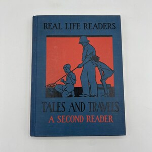 May include: A blue book cover with the title "Real Life Readers Tales and Travels A Second Reader". The cover features an illustration of three people fishing with a net.
