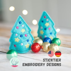 Puede incluir: Dos árboles de Navidad de fieltro turquesa con detalles bordados, incluyendo estrellas y adornos. Los árboles están rodeados de caramelos de colores envueltos en papel de aluminio. La imagen también incluye el texto "STICKTIER EMBROIDERY DESIGNS".