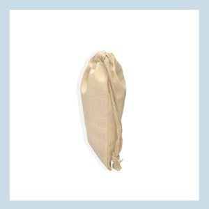 May include: A plain white cotton drawstring bag with a white cotton drawstring.