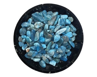 May include: A black bowl filled with blue and green aquamarine tumbled stones.