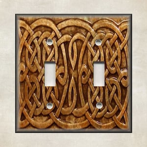 May include: A double light switch cover with a brown Celtic knot design.