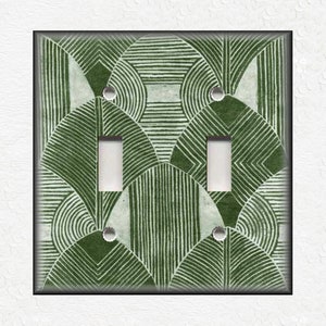 May include: A green and white geometric pattern light switch cover with two toggle switches.