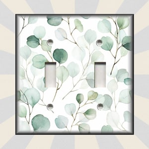 May include: A white light switch cover with a green watercolor eucalyptus leaf pattern.