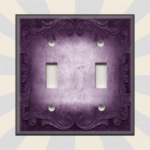 May include: Purple double light switch cover with an ornate, embossed, floral design.