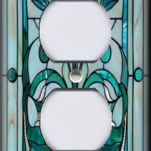 May include: A decorative light switch cover with a stained glass design. The cover features a symmetrical pattern with teal, white, and silver accents. The design includes floral and abstract shapes, creating a unique and artistic look.