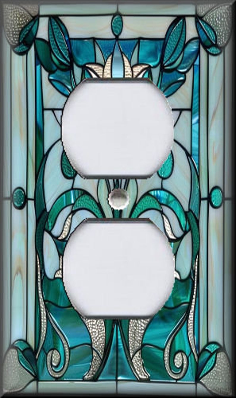 May include: A decorative light switch cover with a stained glass design. The cover features a symmetrical pattern with teal, white, and silver accents. The design includes floral and abstract shapes, creating a unique and artistic look.