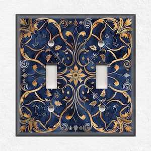 May include: A decorative light switch cover with a blue and gold floral pattern. The cover has two toggle switches.
