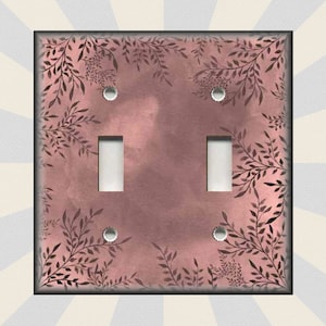 May include: A double light switch cover with a pink background and a black floral pattern.