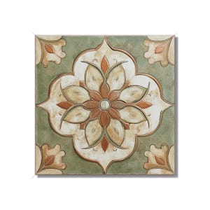 May include: Square ceramic tile with a floral design. The tile features a central flower motif in shades of brown, cream, and white, set against a green background. Decorative corner elements complete the design.