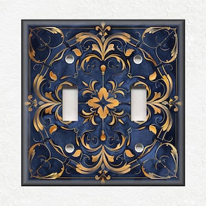 May include: A decorative light switch cover with a blue and gold design. The design features intricate floral patterns and swirls.